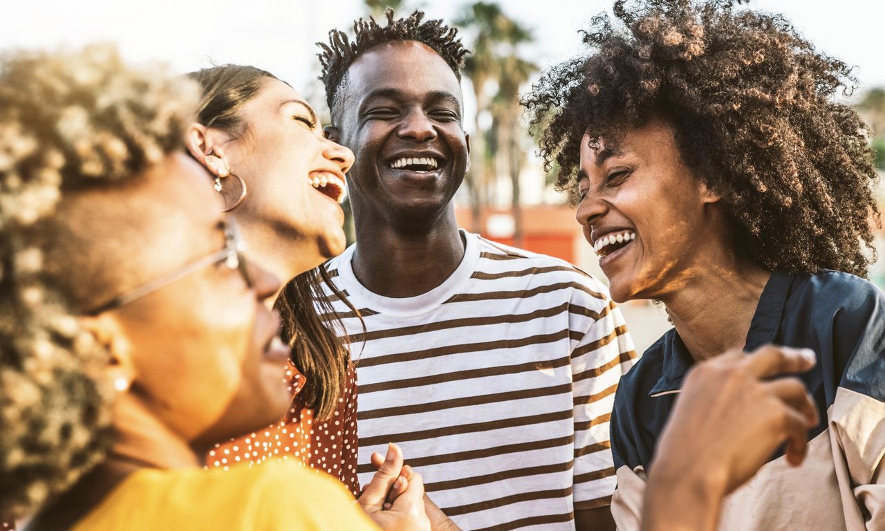 Young happy people laughing together - Multiracial friends group having fun on city street - Diverse culture students portrait celebrating outside - Friendship, community, youth, university concept
